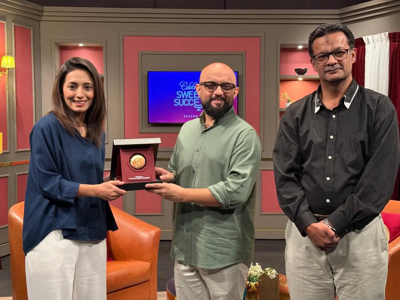 Sarah Mashhood receiving the Institute of Business Management shield on the Celebrating Sweet Success set